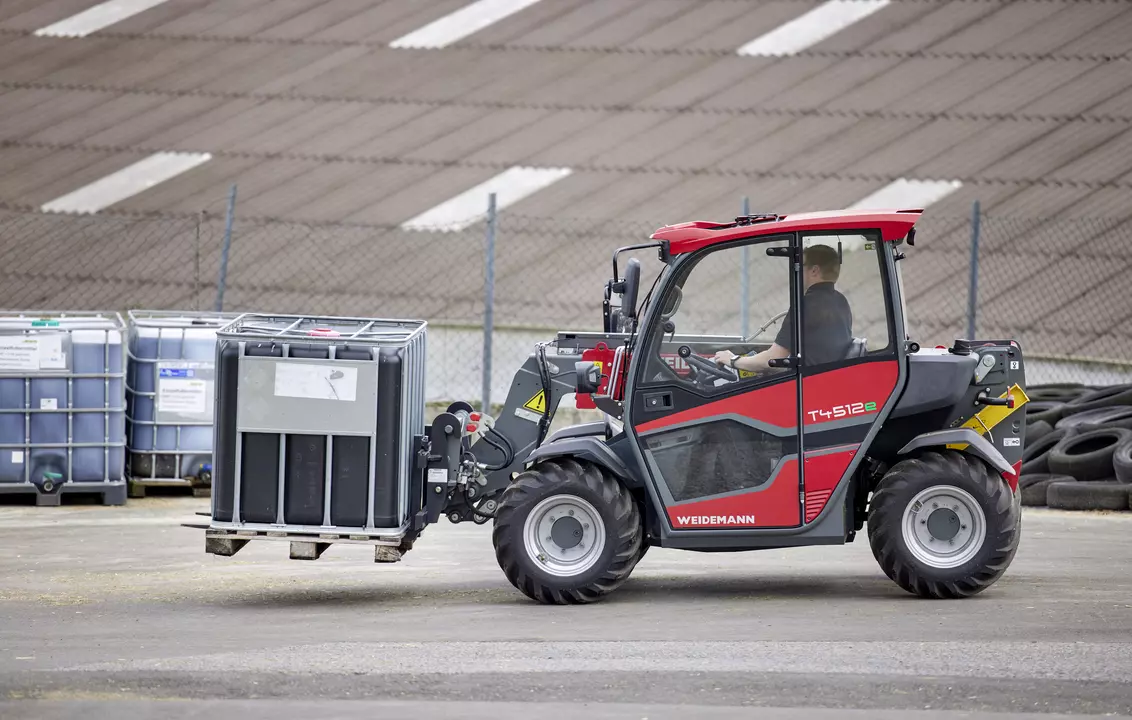 Weidemann T4512e telehandler with pallet fork in use on a farm