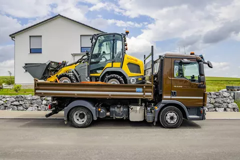 The 5045 wheel loader is transported on a trailer.