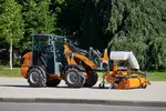 Weidemann attachment Rotary sweeper 25, in action municipality, Hoftrac 1260LP