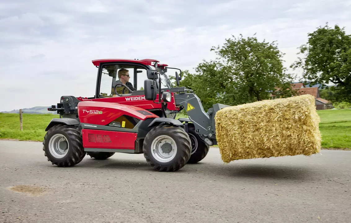 Weidemann telehandler T4512e with bale spike on an agricultural farm