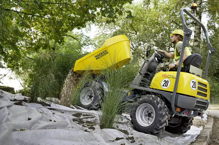 1501s wheel dumper tips stones onto a weed tile when redesigning a garden area