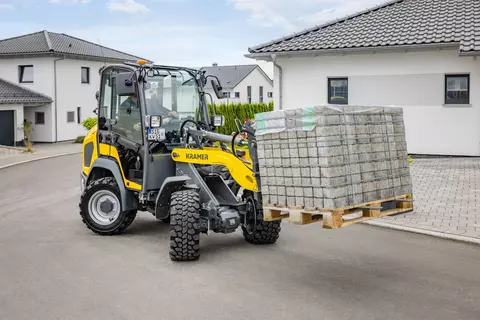 The 5045 wheel loader moves a pallet of stones to the construction site.