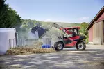 Weidemann T4512e telehandler with gripping bucket in use on a farm