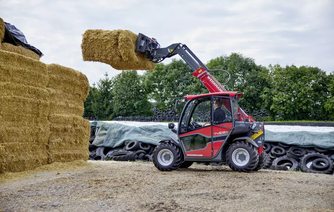 Weidemann telehandler T4512e with bale spike on an agricultural farm