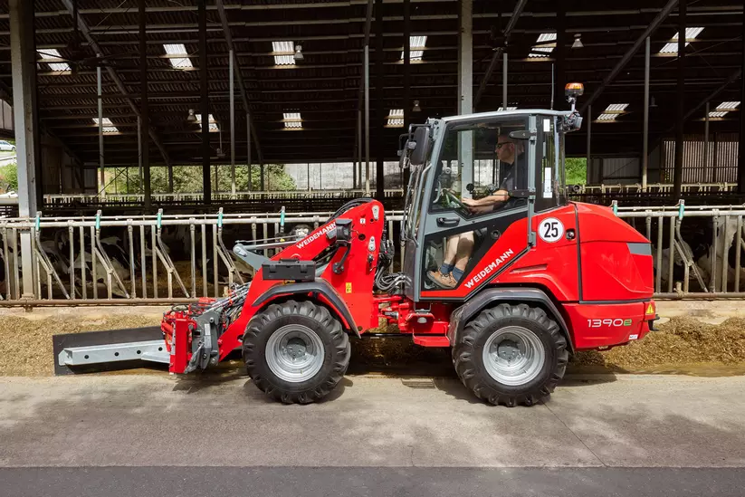 Weidemann Hoftrac 1390e mit hydraulischem Futterschiebeschild im Einsatz