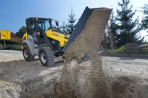 Der Kramer Teleskopradlader 5065T beim Verladen von Erde.