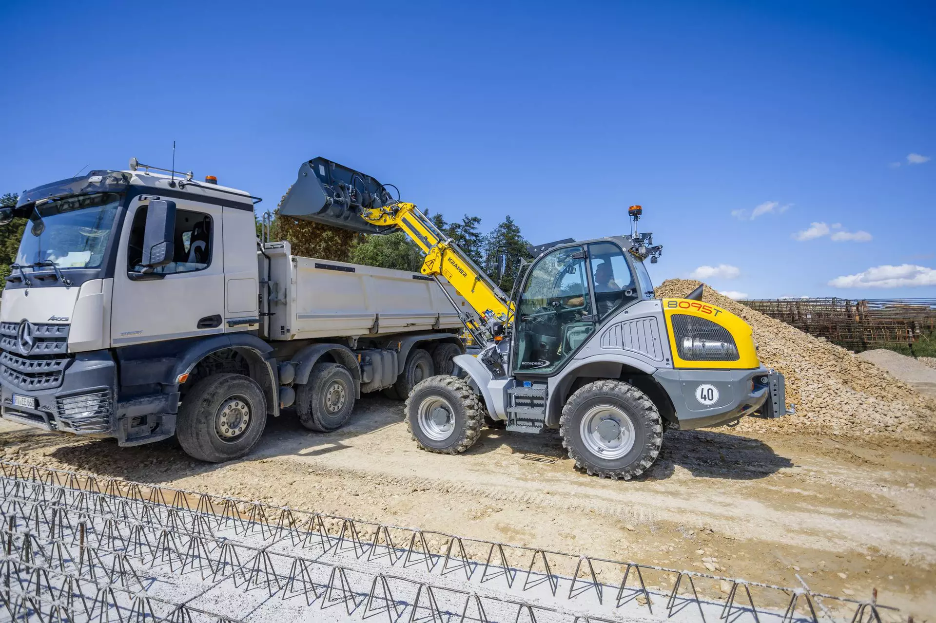 The Kramer telescopic wheel loader 8095T while dumping stones.