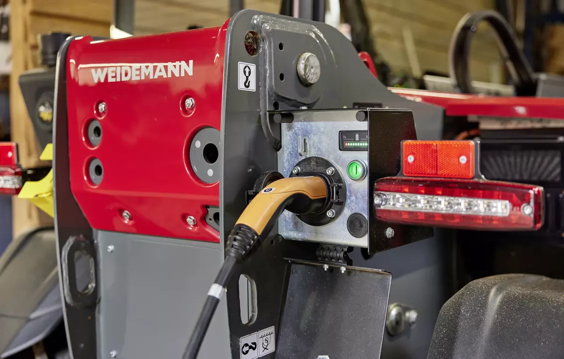 Weidemann telehandler T4512e during loading process on an agricultural farm