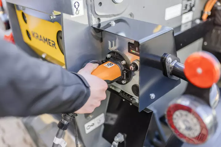 The fully electric Kramer telehandler 1445e during charging process.